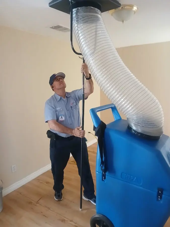 Furnace Tune-Up technician using HEPA equipment in Macon